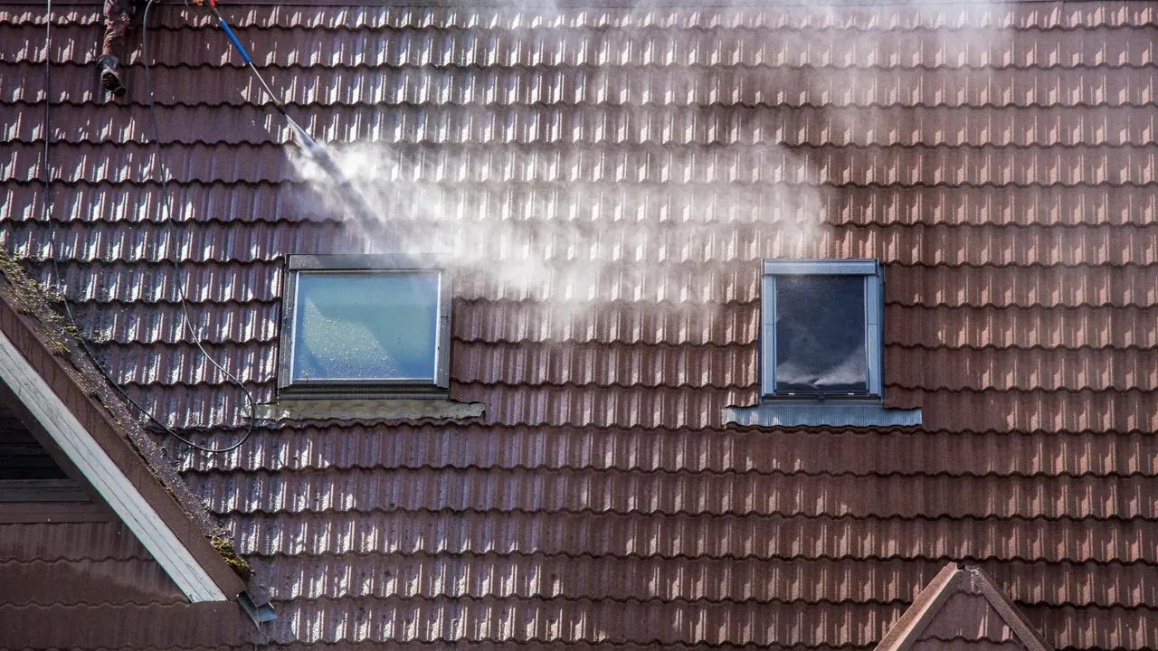 Roof tiles being cleaned with a pressure washer