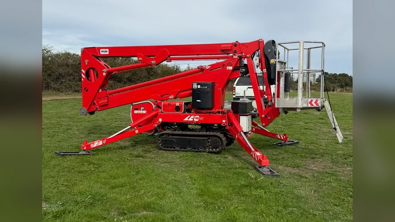 Operated cherry picker hire, compact tracked cherry picker folded on grass ready for a job